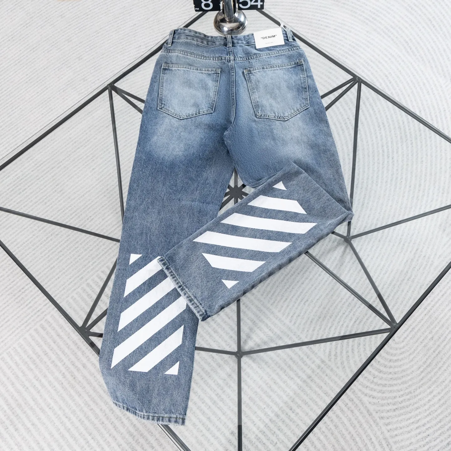 Off-White 26ss New Arrival Classic trendy brand twill zebra stripe straight-leg jeans are designed with the brand's Classic zebra stripe print as the core design. The twill logo on the back is fully recognizable, and the "OFF" small logo on the front echoes in a low-key manner, perfectly interpreting the aesthetics of street fashion brands. Heavy denim fabrics are selected and processed with washed and distressed techniques to present a natural Retro blue texture. The fabric is stiff, Wear-Resistant and comfortable to wear. The straight and loose cut flatters the shape of the legs, is not flattering to the body shape, and is suitable for various tops, whether it is street style or simple casual style, it can be easily worn. The brand tags and edge stitching in the details all restore Authentic craftsmanship. It is a hard-core Versatile item in the fashionable wardrobe, with its own topicality and trendy attributes. Size: 30-36 Color: Blue