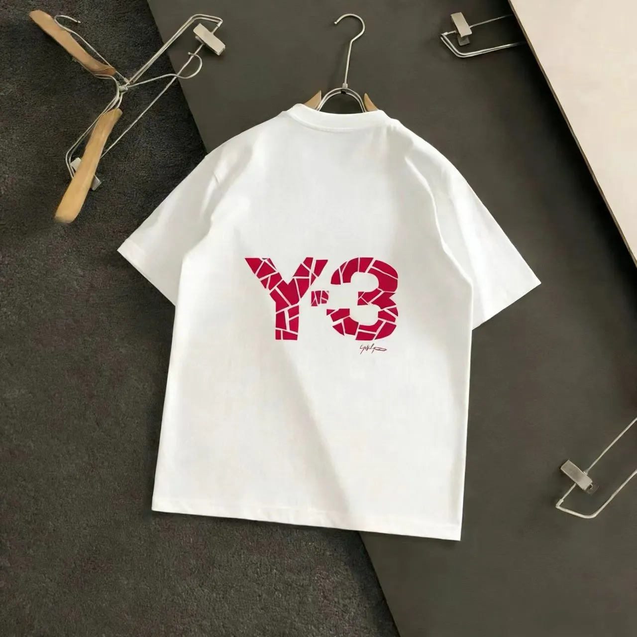 "𝙉𝙚𝙬🤍🖤Y 3 Home" Y-3 short sleeves are an innovative fusion of trend and personality! Simple and refreshing, giving people a clean and neat feeling. The design on the back is amazing! Red's "Y-3" lettering adopts a unique fragmented splicing style, which is full of personality, like an artistic creation that breaks the rules. There is Red's signature style next to it, adding a bit of casualness and uninhibitedness. M-XXXL